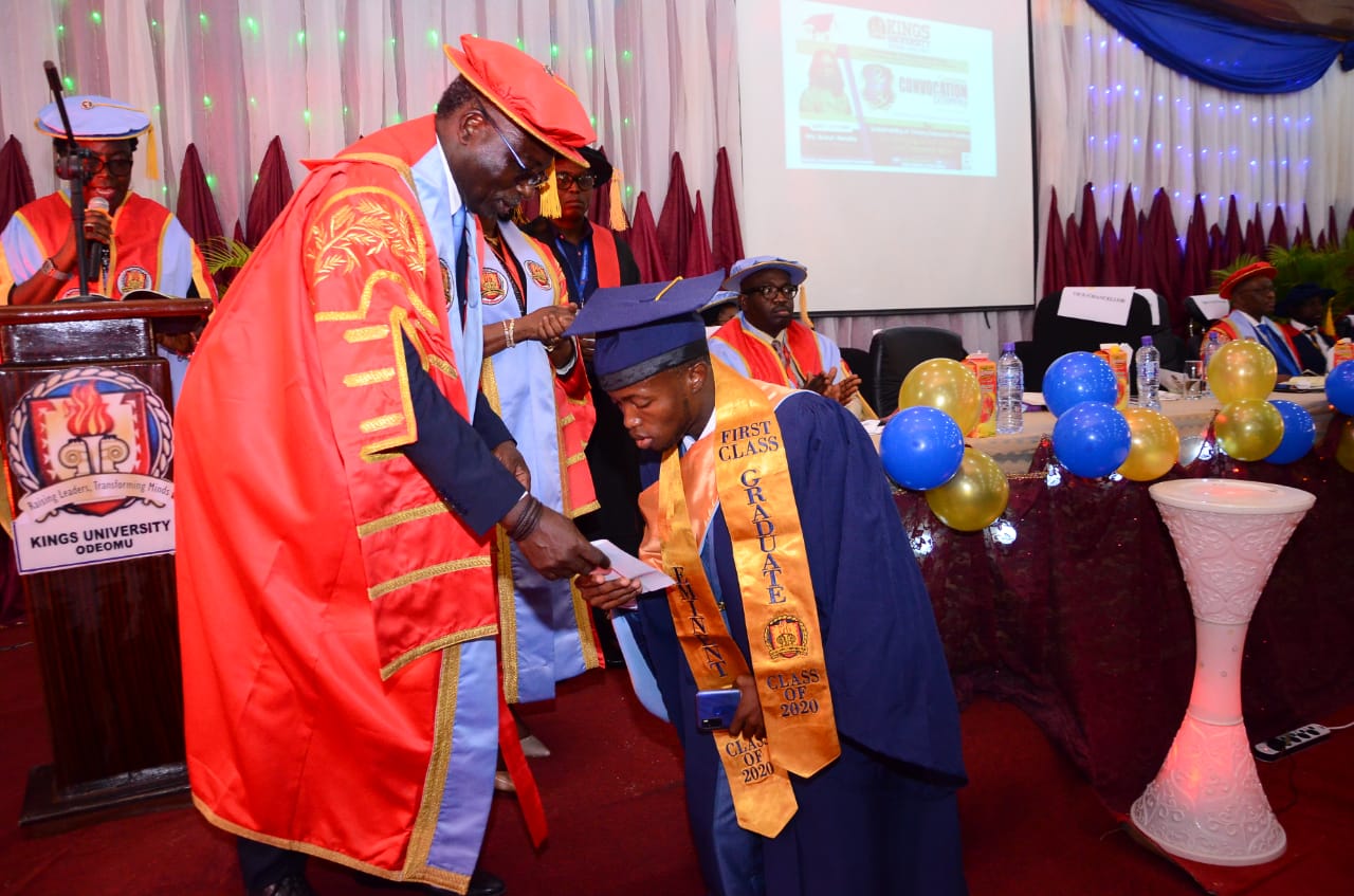 Award winning graduate Emmanuel Ogo in a  handshake with the Chancellor